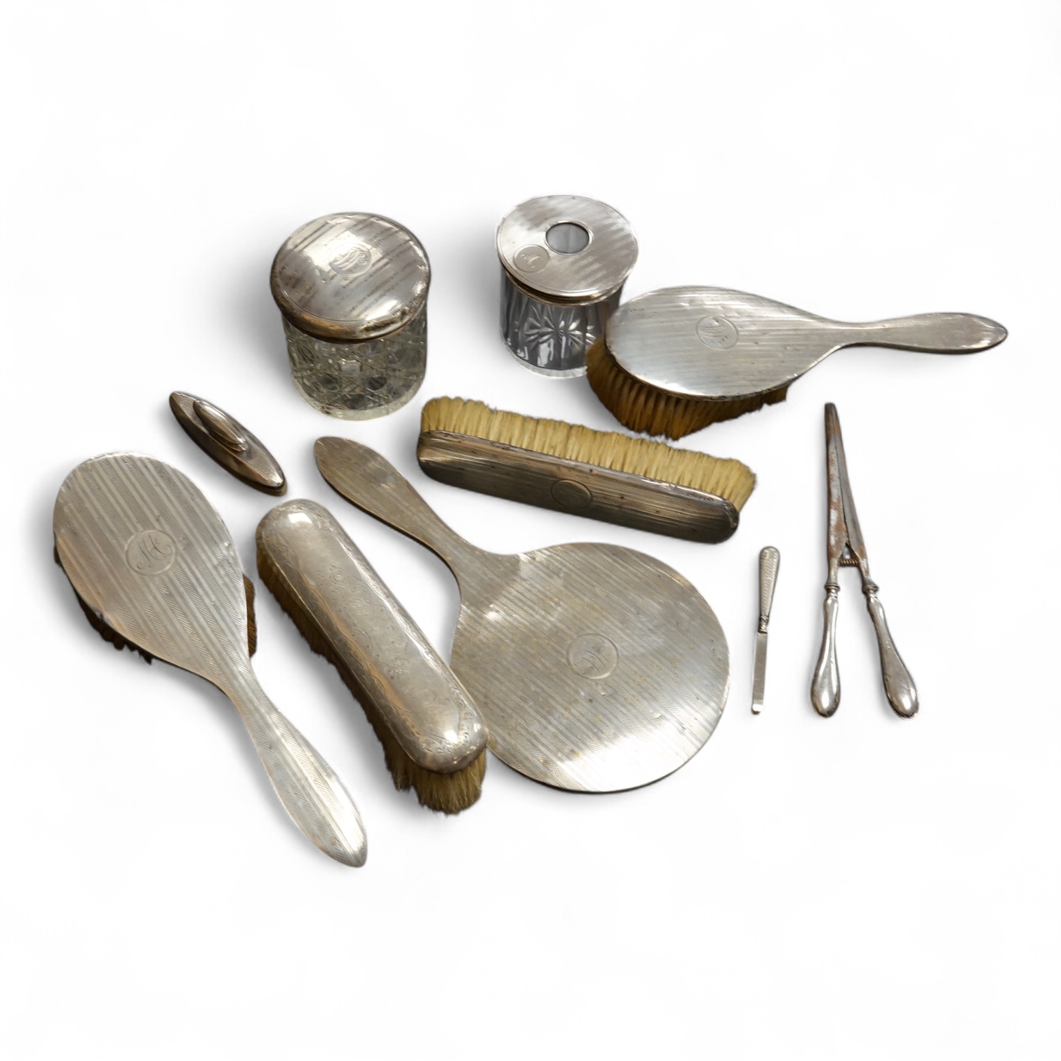 Ten assorted silver mounted dressing table items, including brushes, hand mirror, manicure items and glove stretchers.